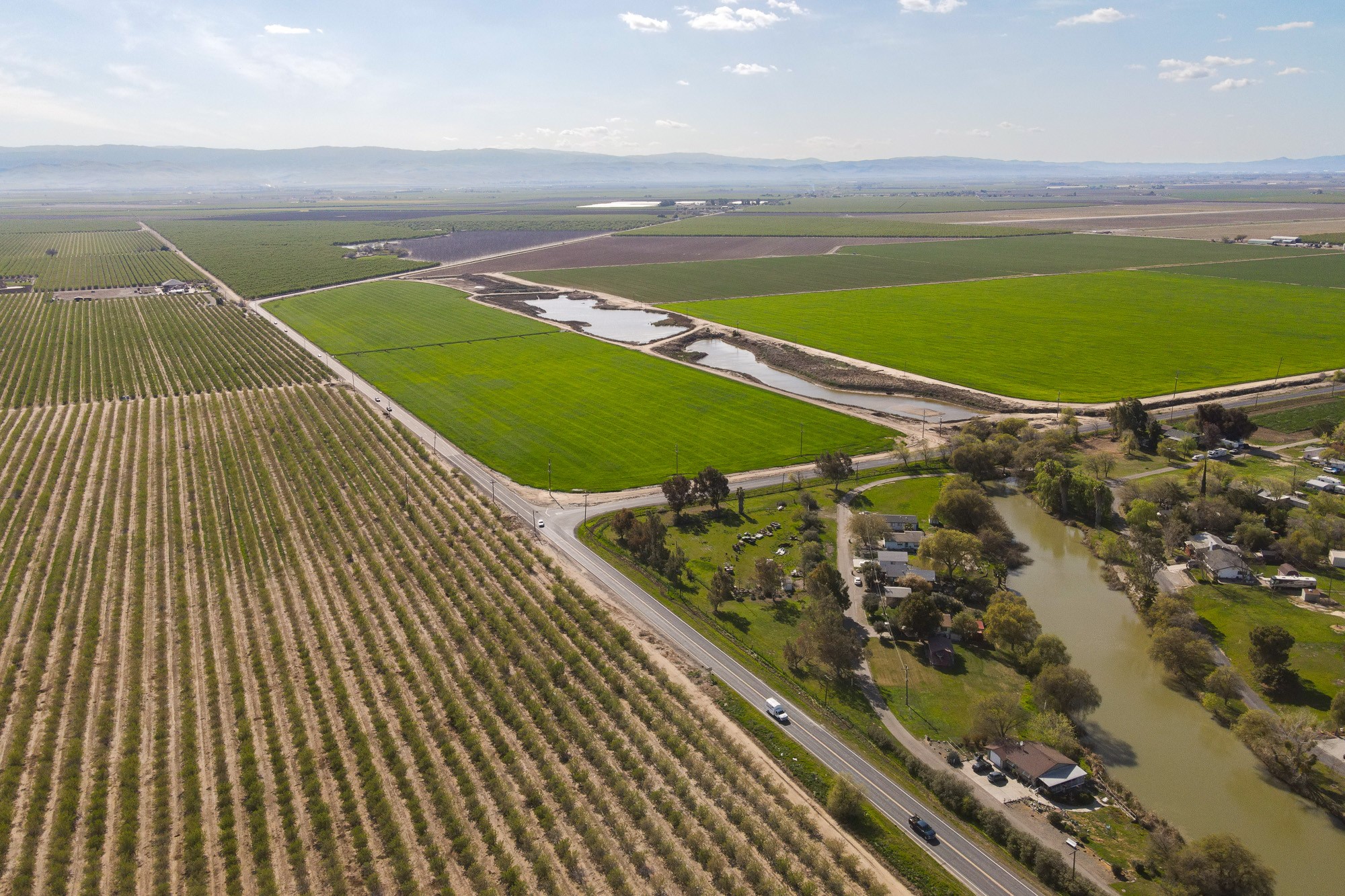 drone shot of San Joaquin Valley farms, water and housing.