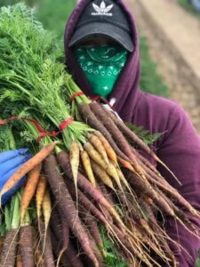 farmer in mask with carrots