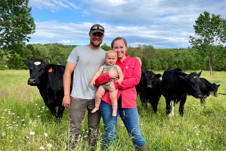 Tucker Kautz and family standing in beef pasture