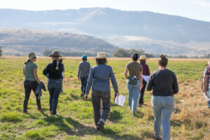 Women farmers walk across field in Oregon. 