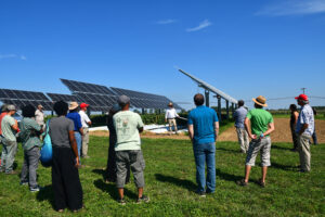 TAPAS attendees learning from David Specca in front of an agrivoltaic system.